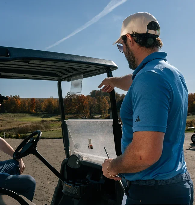 Golf club manager overviewing course operations in Tee On